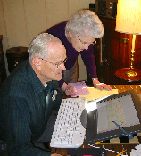Photo of two grandparents using a computer