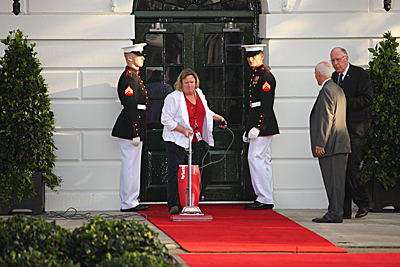 Lady Vacuuming Red Carpet