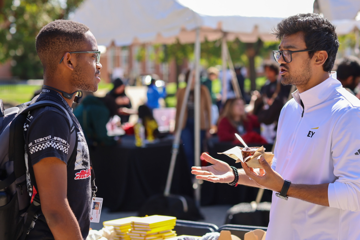2 people talking at the EY table