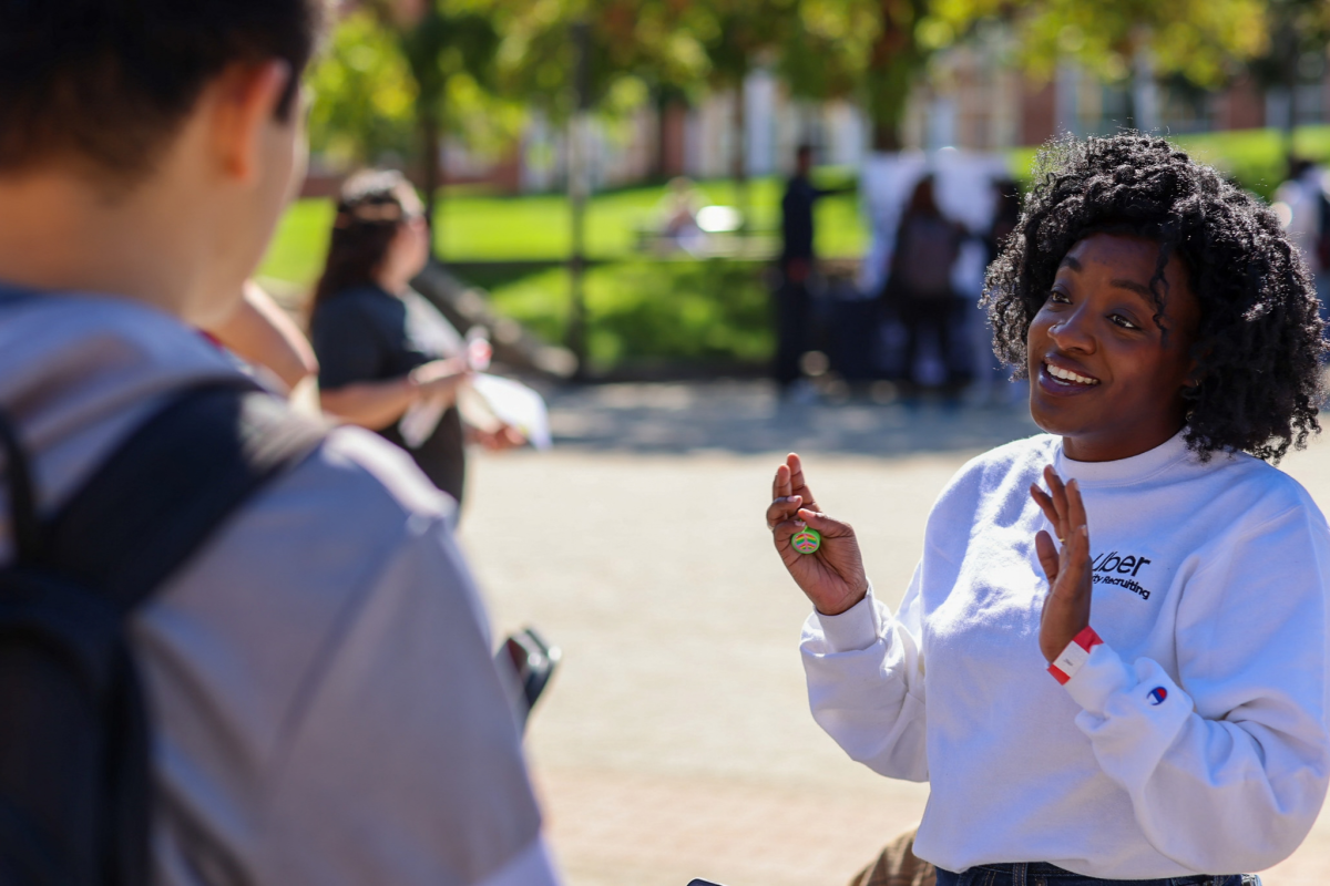 A representative from Uber speaks with students