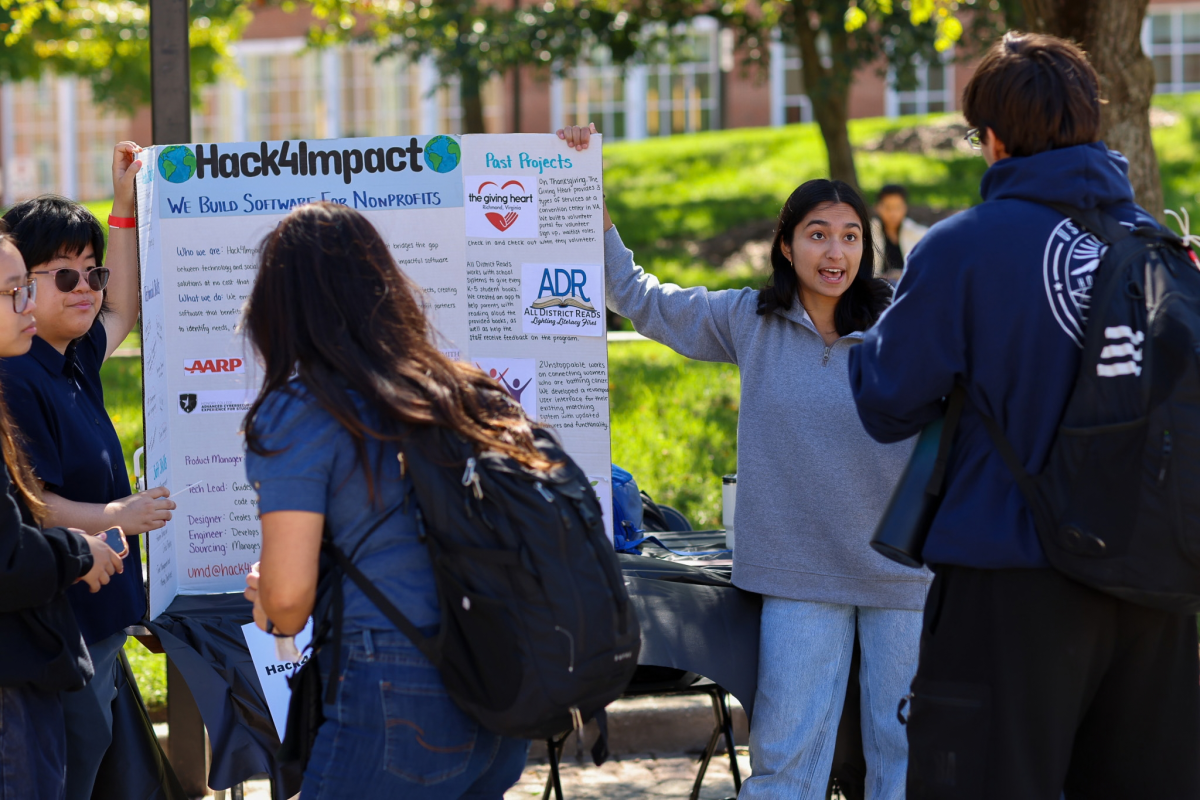 Students gathered at the Hack4Impact table