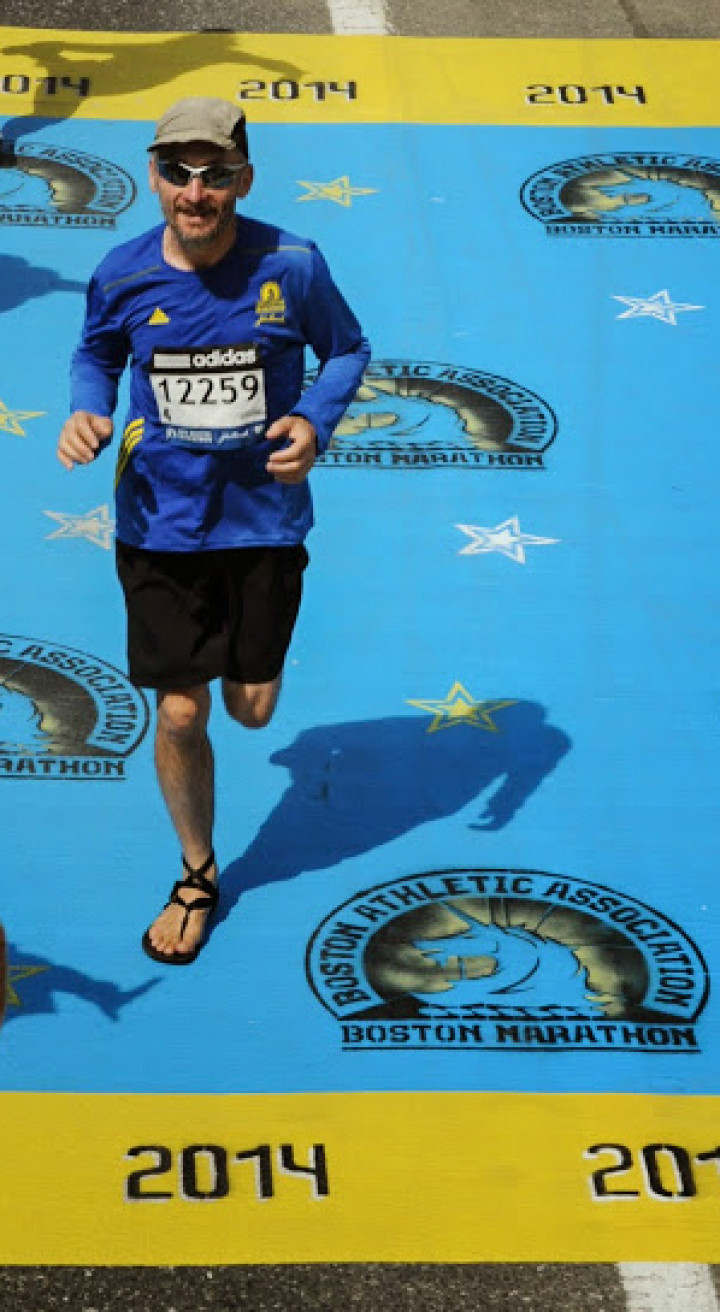 photo of Smiling and looking relaxed, Sergey crosses the finish line in Boston.