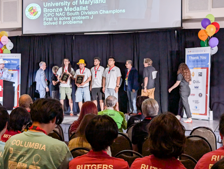 photo of The University of Maryland team stands on the podium as Bronze Medalists at the ICPC North American Championship (NAC) 2024. Image courtesy of Ilya Hajiaghayi.