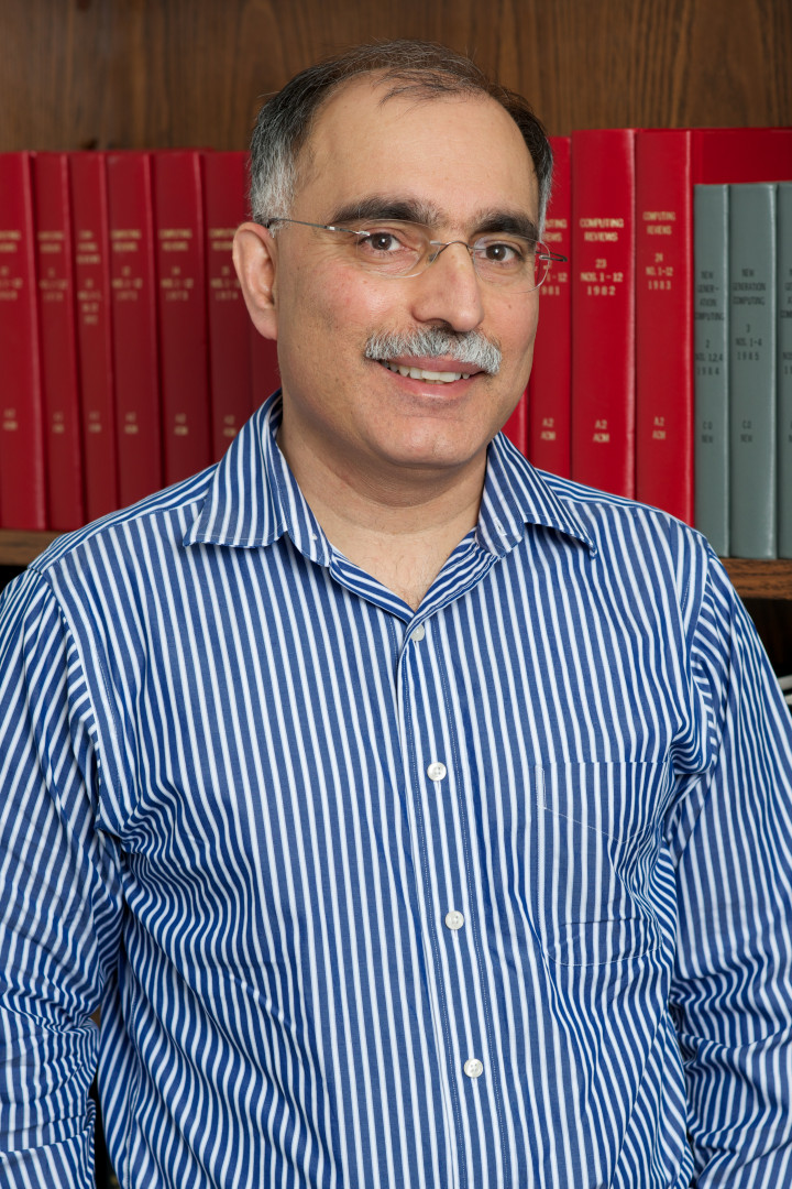 Samir Khuller in front of bookcase