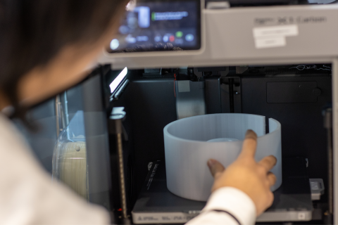Researcher placing medium into an oven
